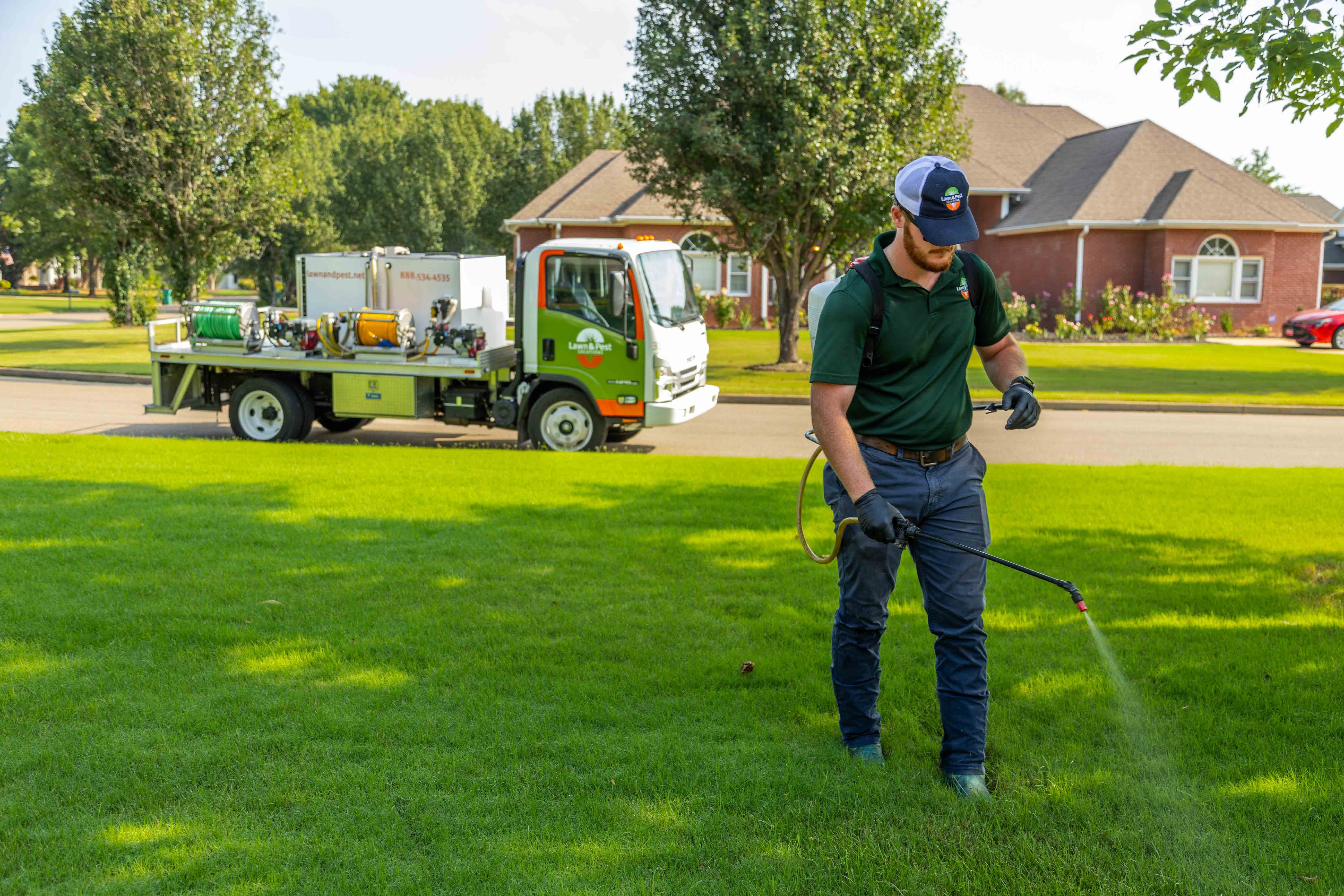 lawn care truck technician crew spot treatment weeds backpack spray hose action 3