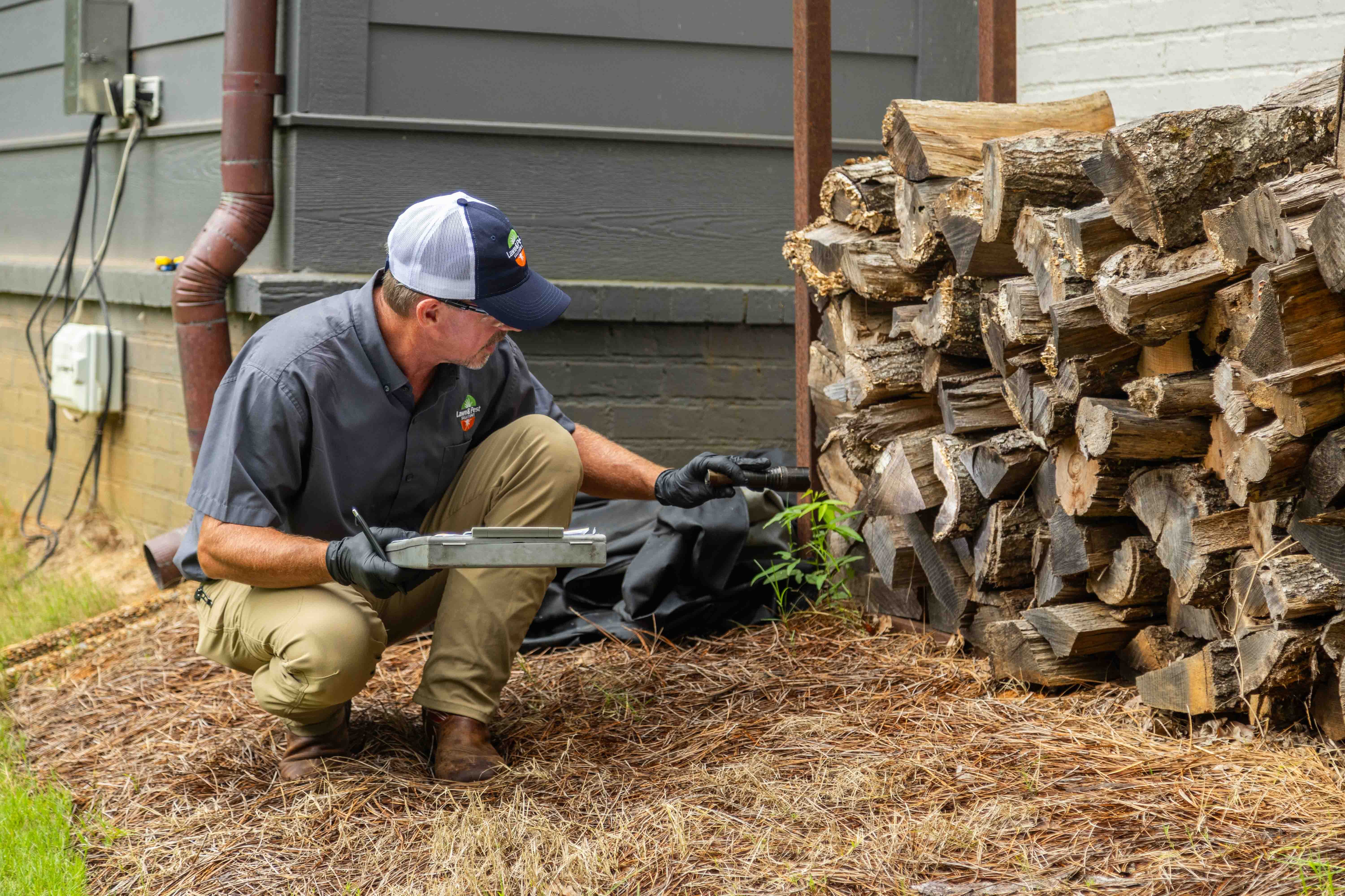 pest control tech crew fire wood pile inspection 3