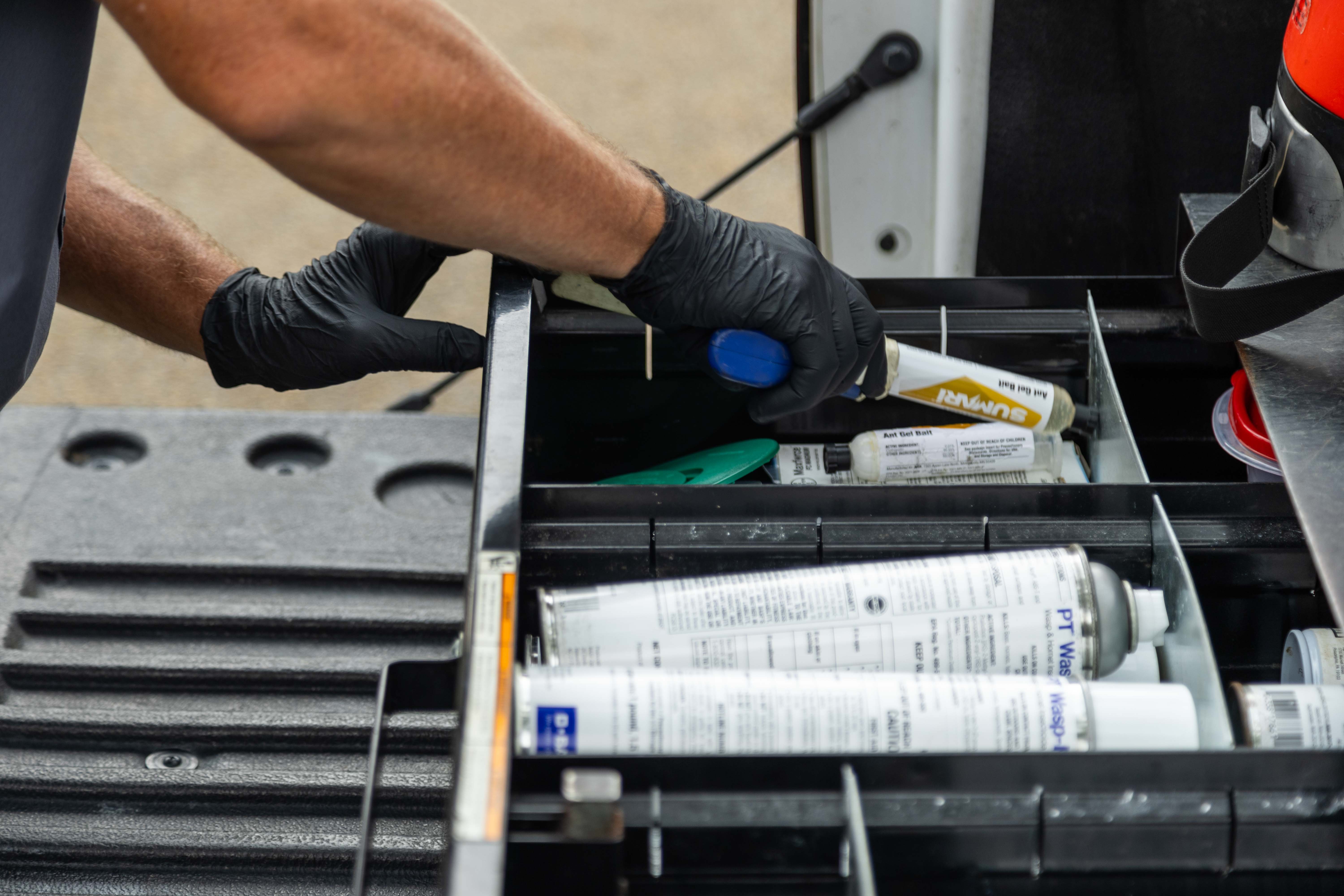 pest control technician preparing equipment in a truck