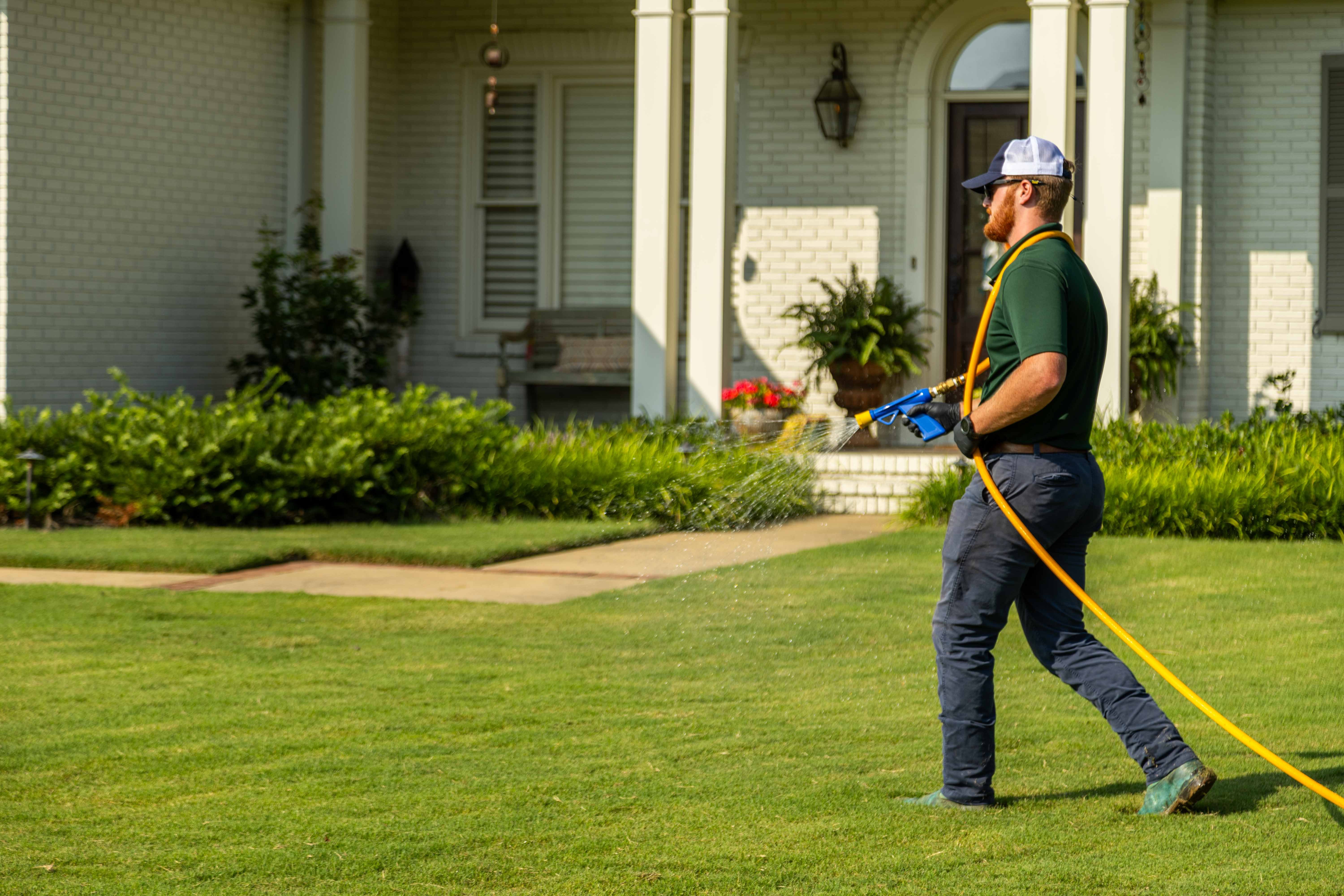 technician crew spray hose weed control lawn care grass green treatment home 3