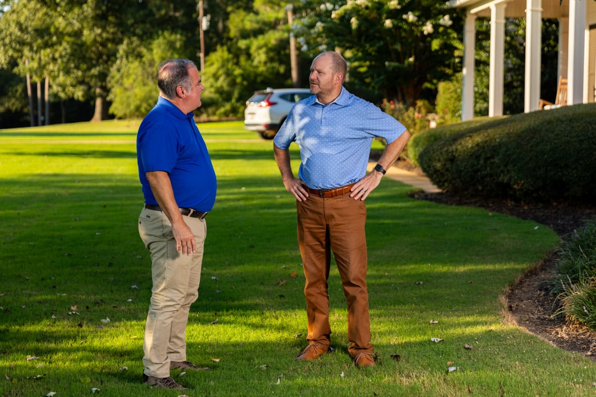 lawn care account manager and customer inspecting lawn 4