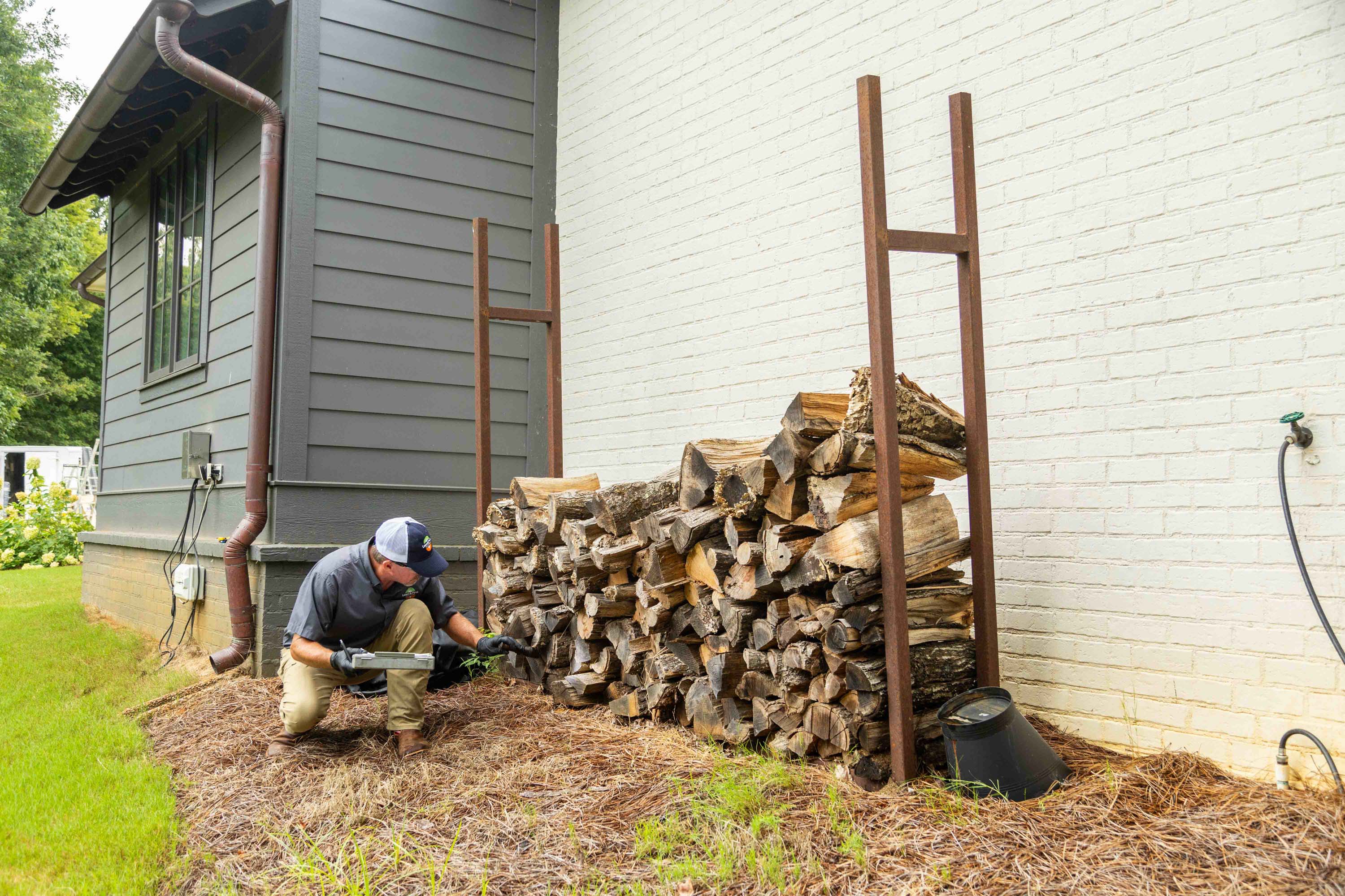 pest control tech crew fire wood pile inspection-1