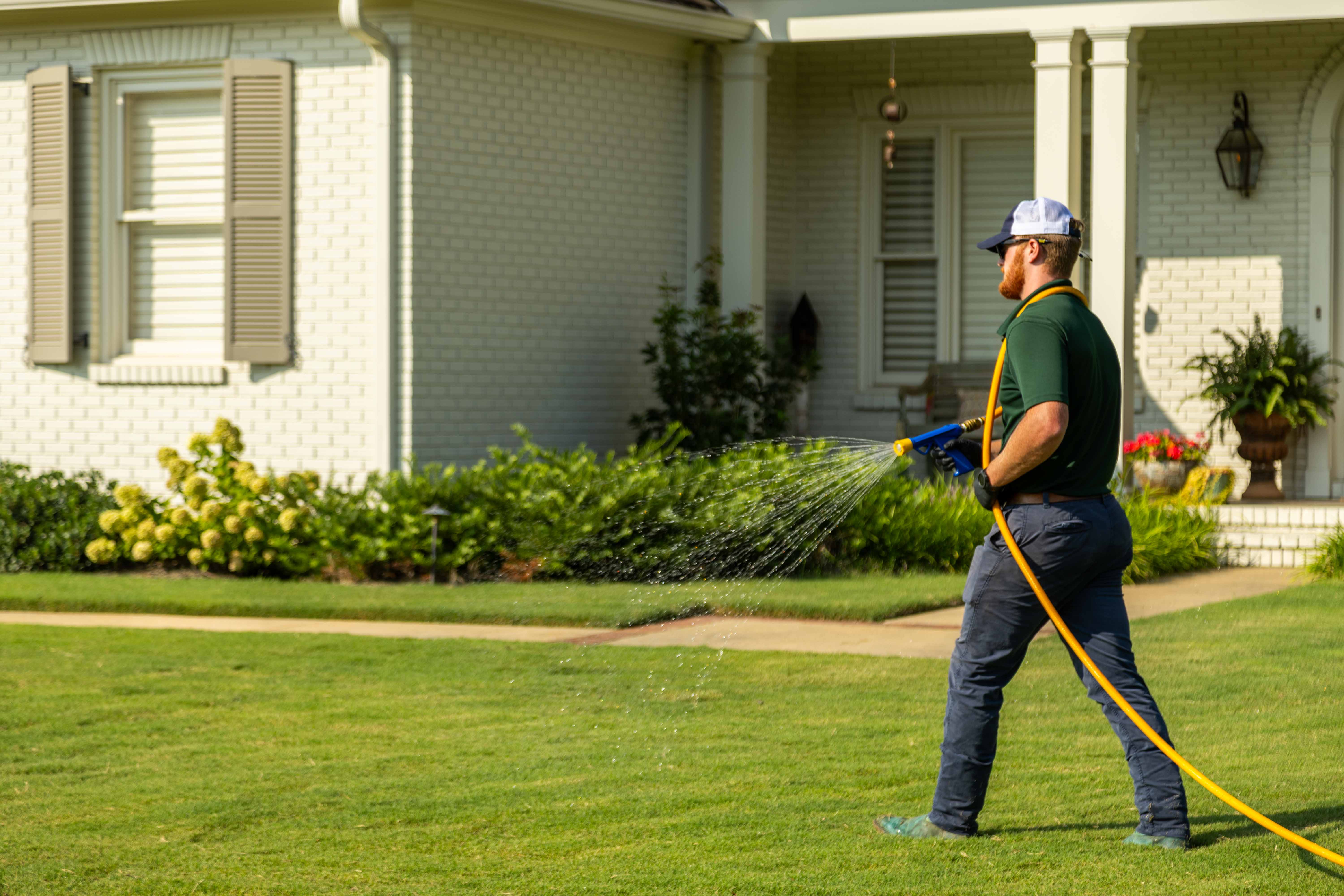 technician crew spray hose weed control lawn care grass green treatment home 4