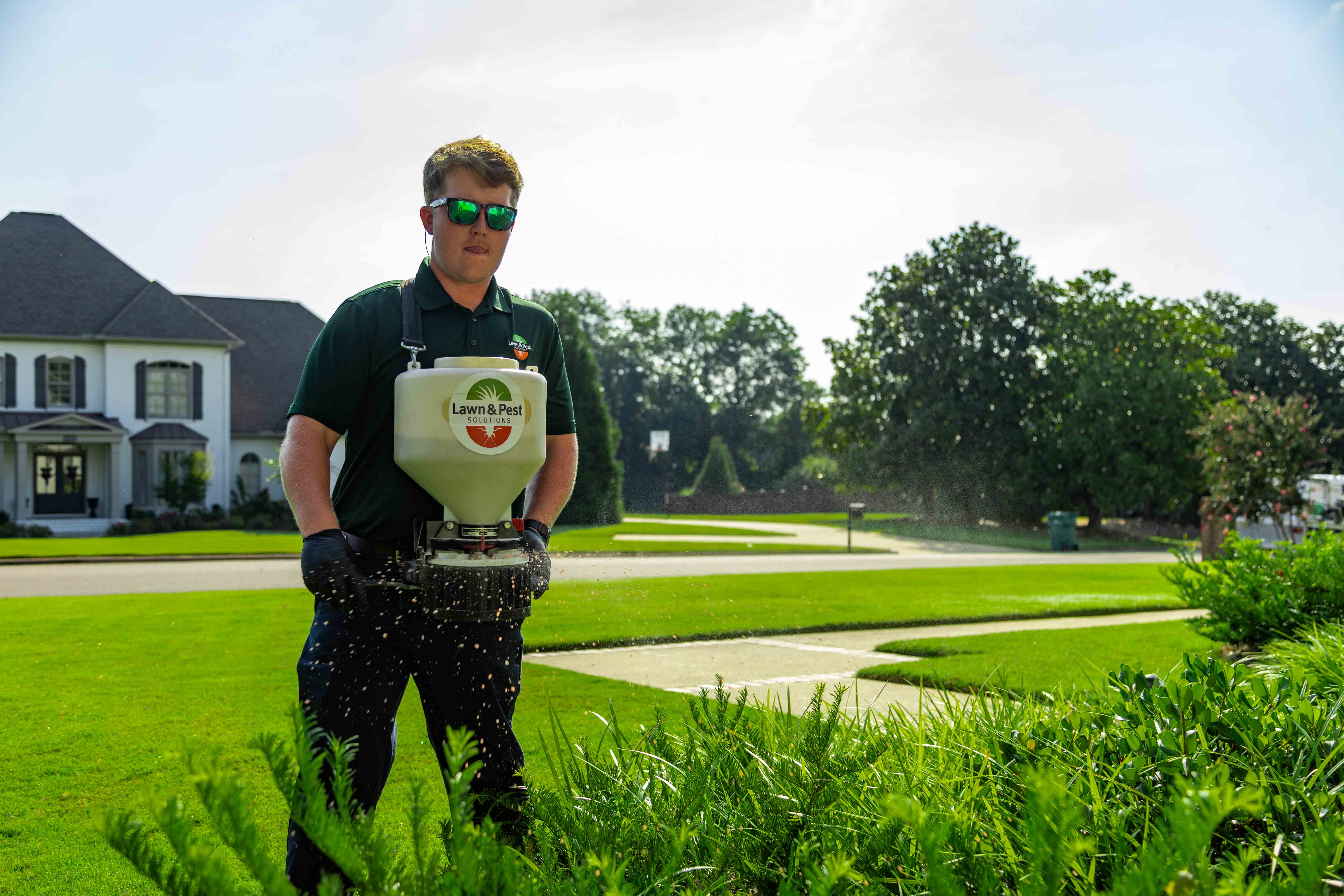 technician plant health care spreader grinder shrubs treatment granular beds fertilizer